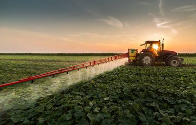 Agricultural machinery standing in a field ahead of an equipment auction